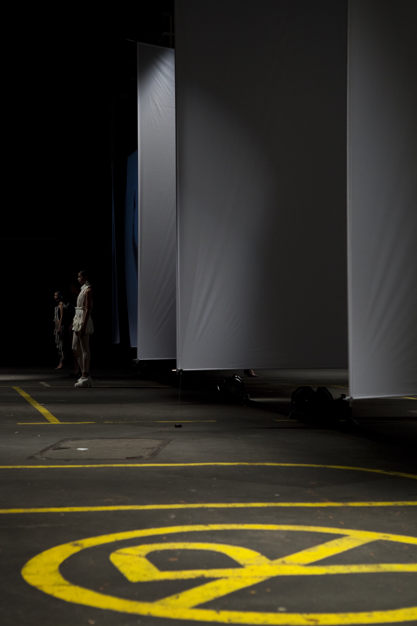 Sails and fashion models in an industrial dark environment