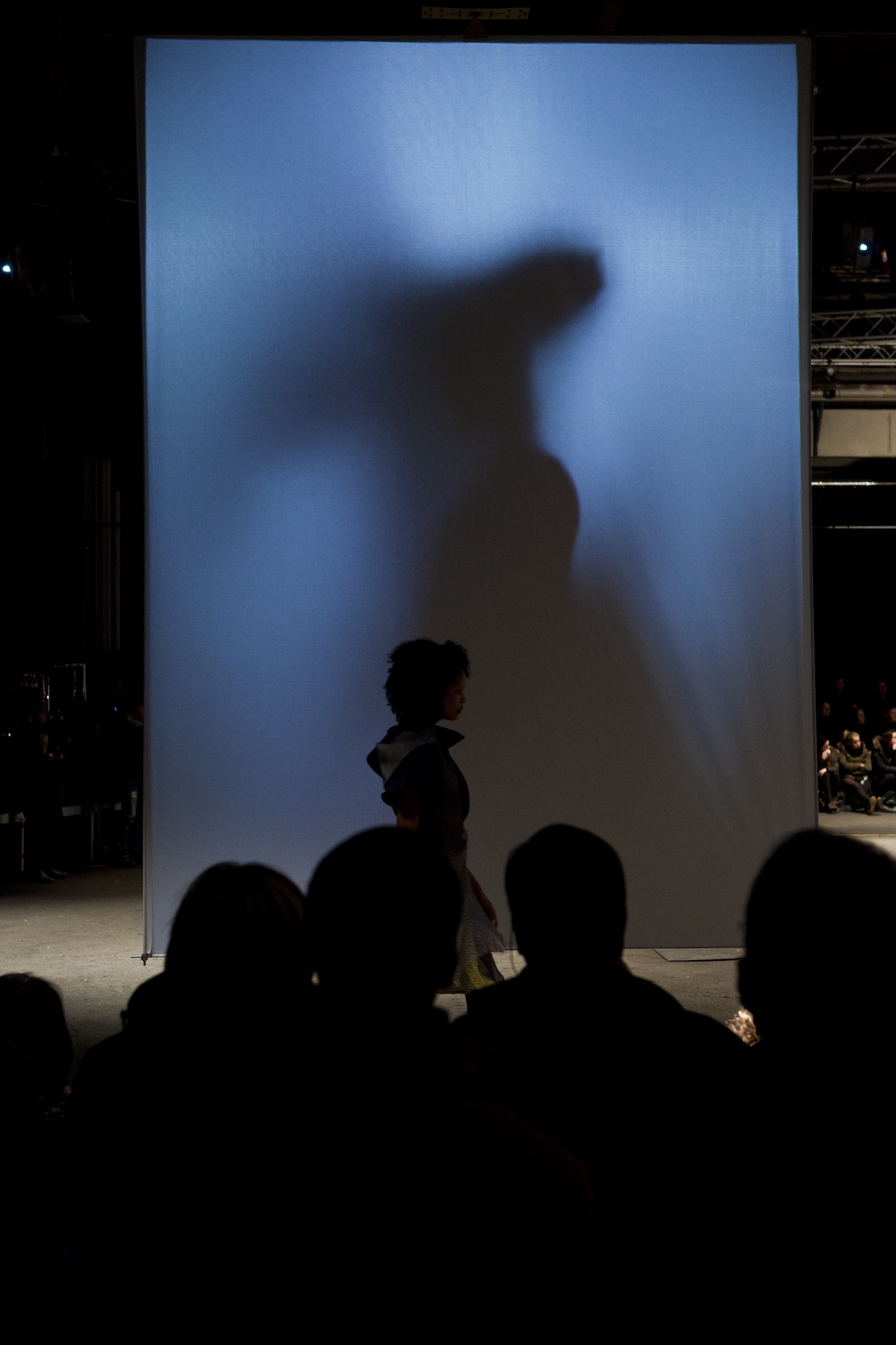 Fashion model walking in front of projected sail